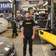 Mike Burroughs stands in the midst of a messy shop.